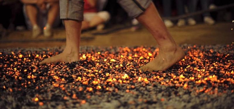 Jason walking across burning coals